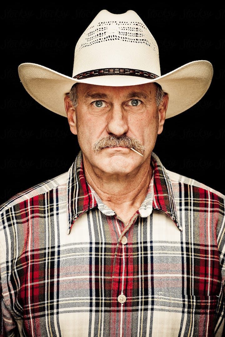 A man with a white cowboy hat and plaid shirt.